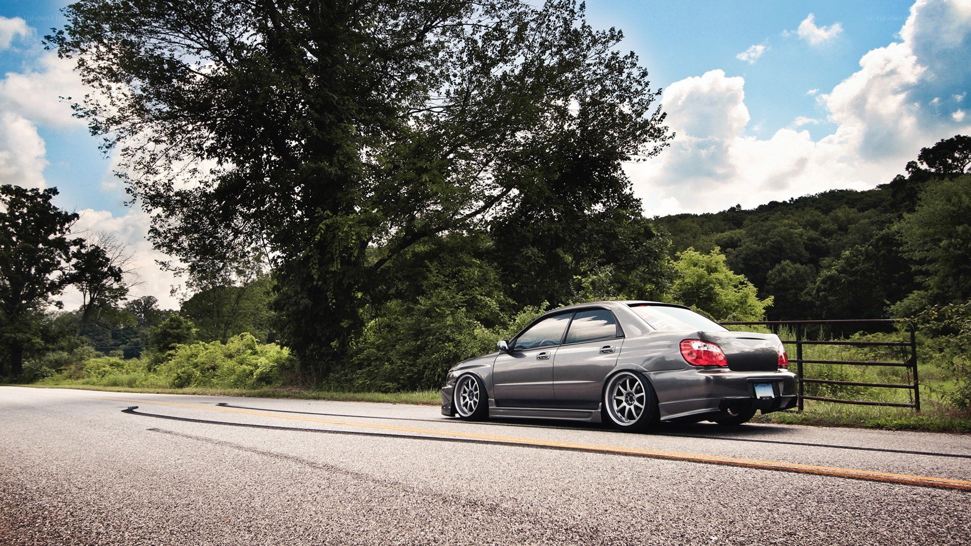 gray sedan on rural road