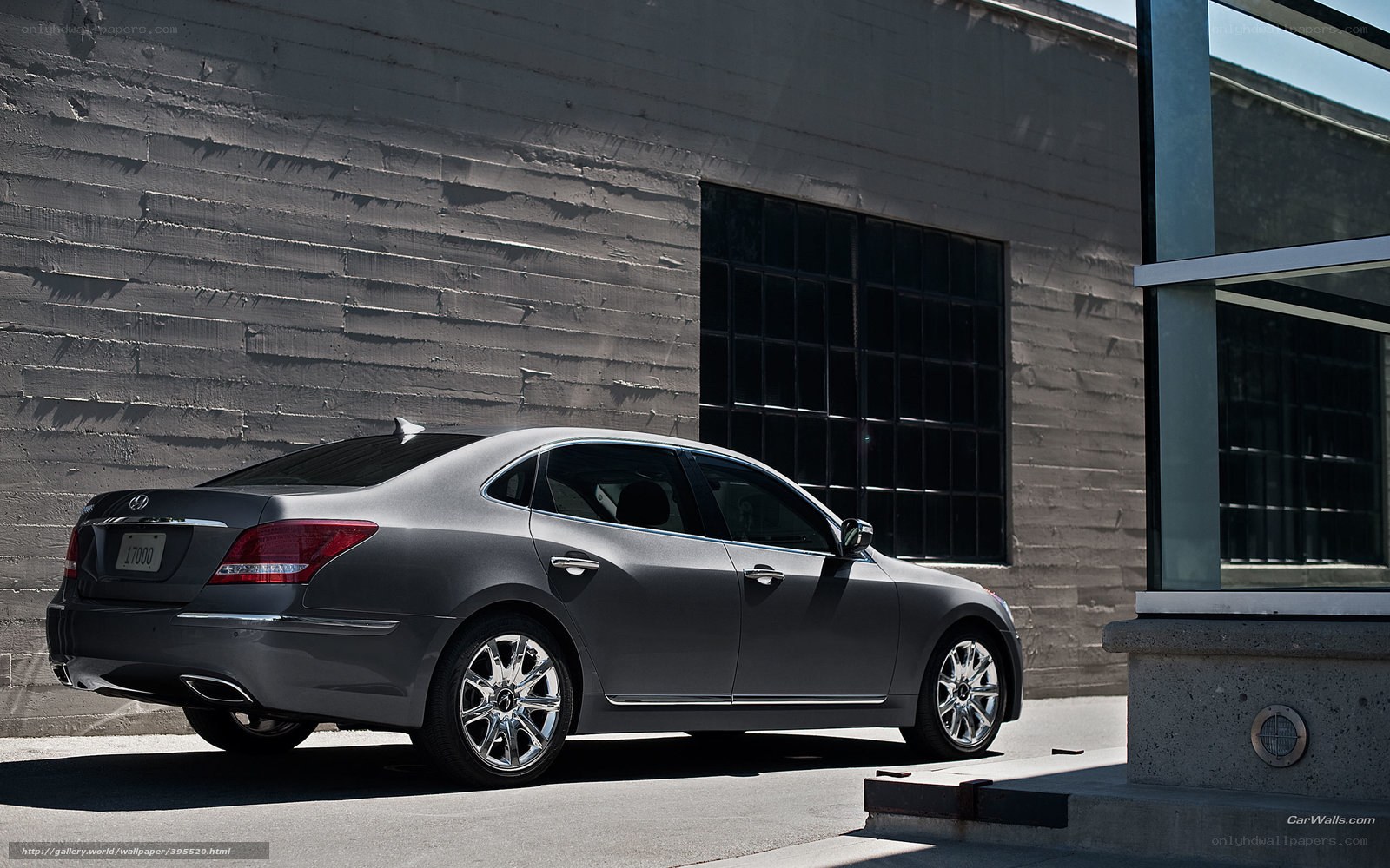 Gray sedan parked by building