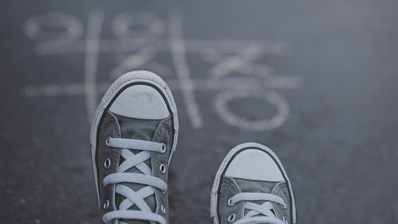 Gray Sneakers on Pavement
