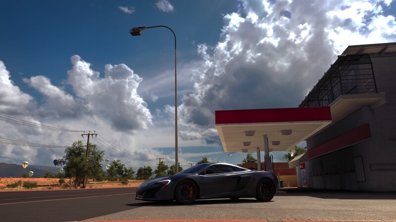 Gray Sports Car at Gas Station
