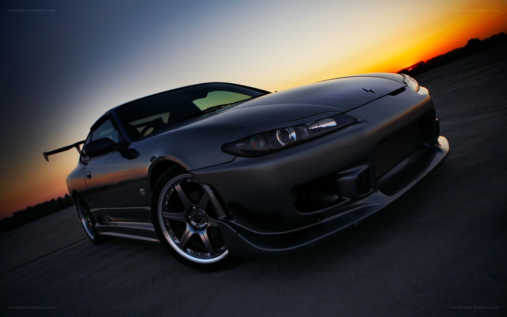 gray sports car at sunset