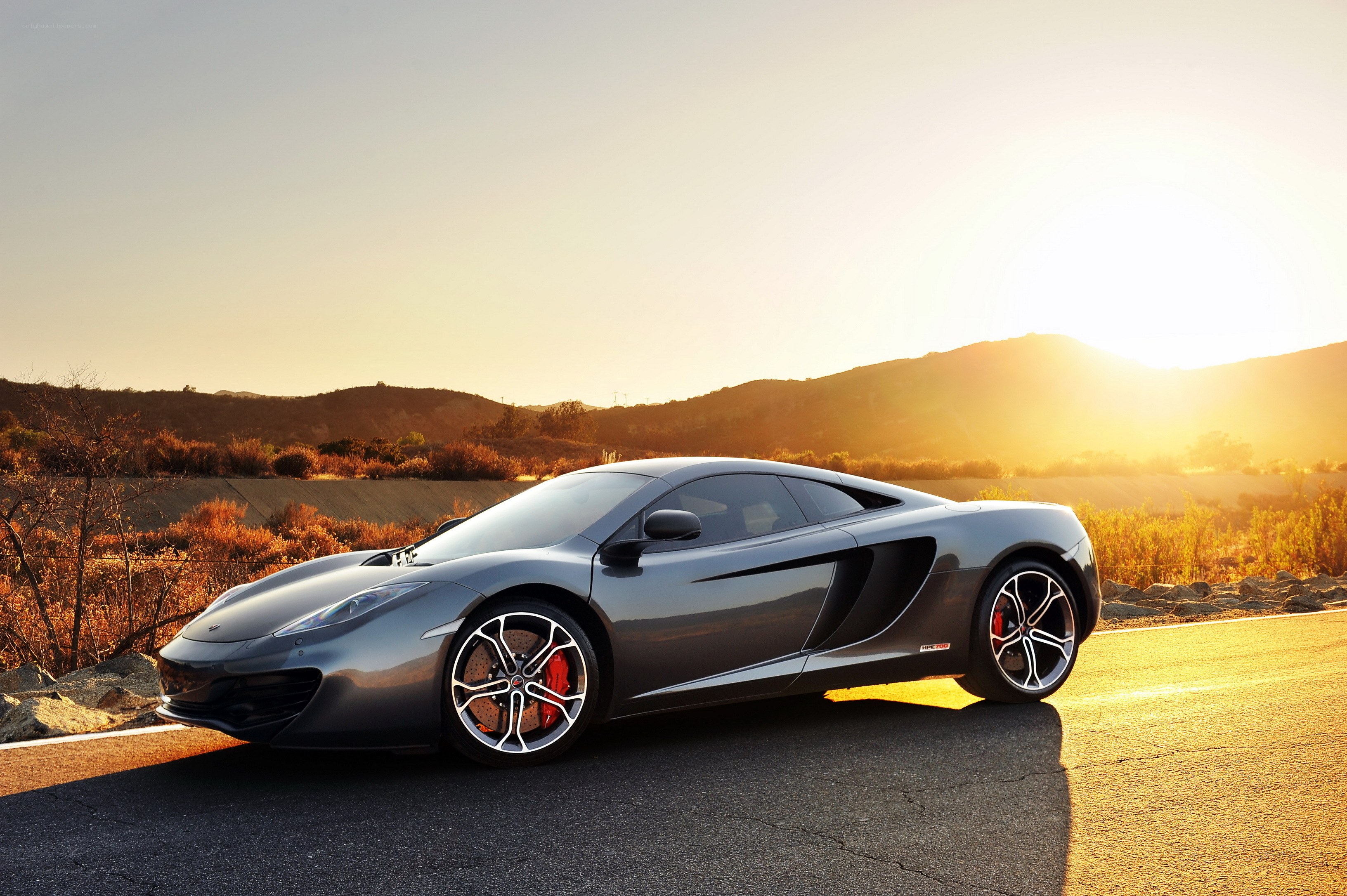 Gray sports car at sunset