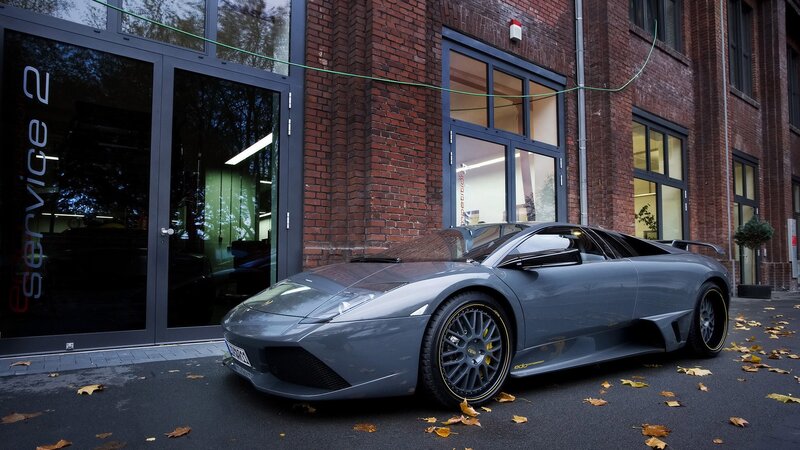 Gray Sports Car — Calm, Autumn, Photograph, Brick Building, Glass Doors