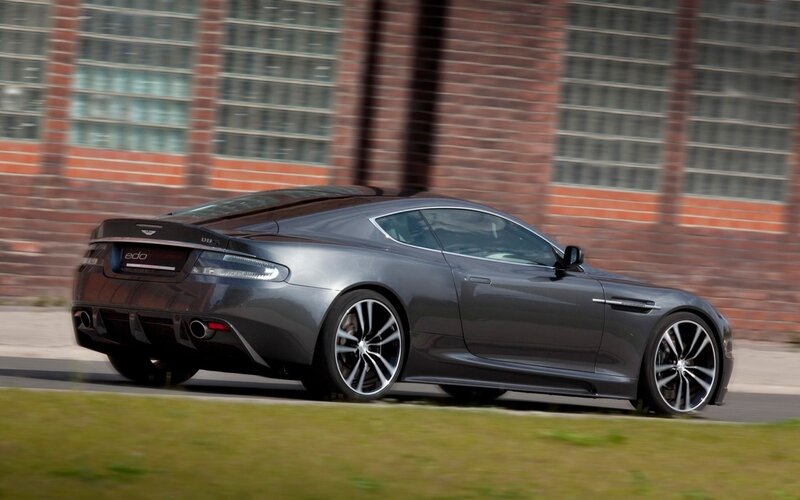 Gray Sports Car — Dynamic, Photograph, Brick Building