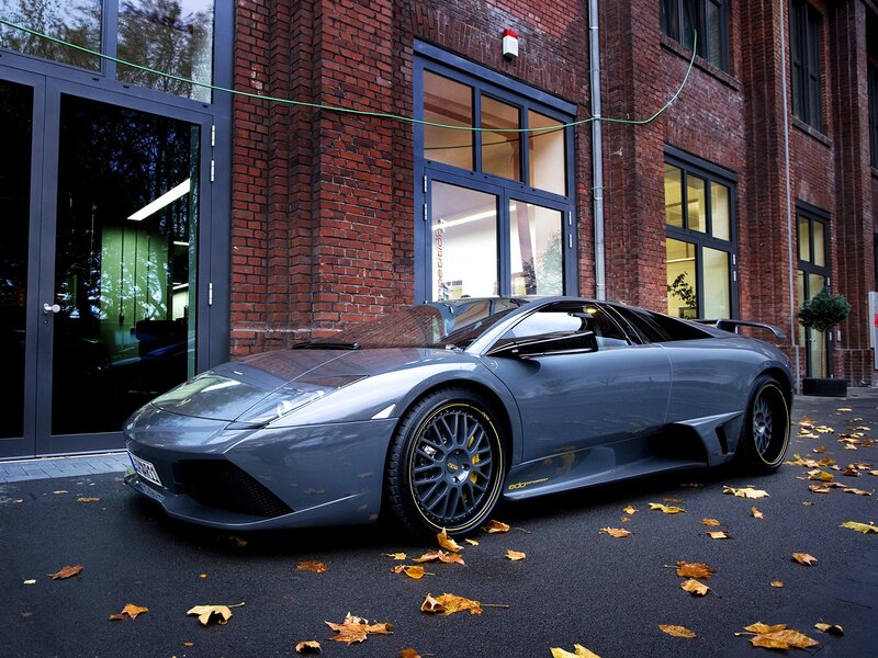 gray sports car in front of brick building
