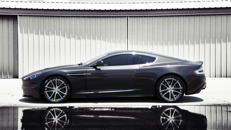 gray sports car in front of garage