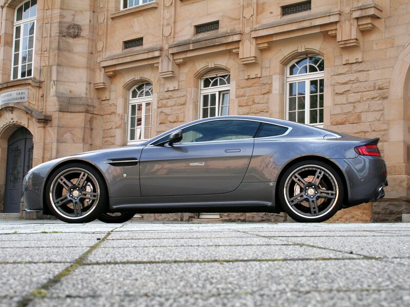 Gray sports car in front of stone building