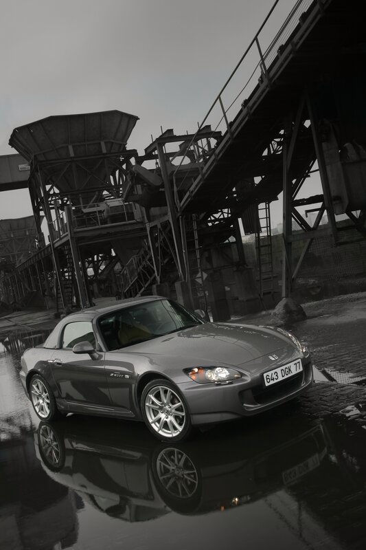 Gray sports car in industrial setting
