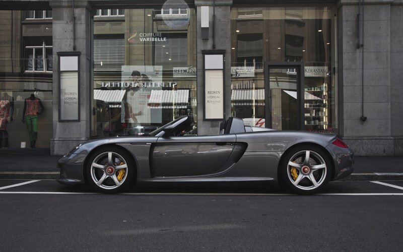 Gray sports car on city street