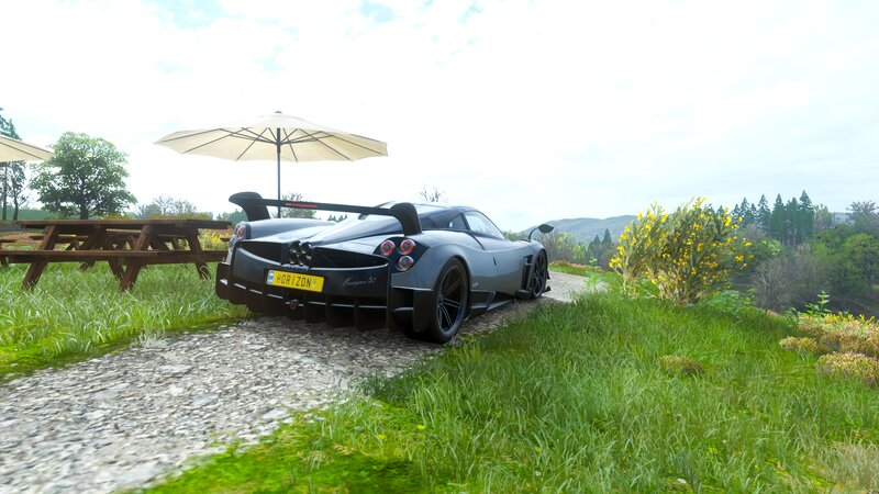 Gray Sports Car on Gravel — Green