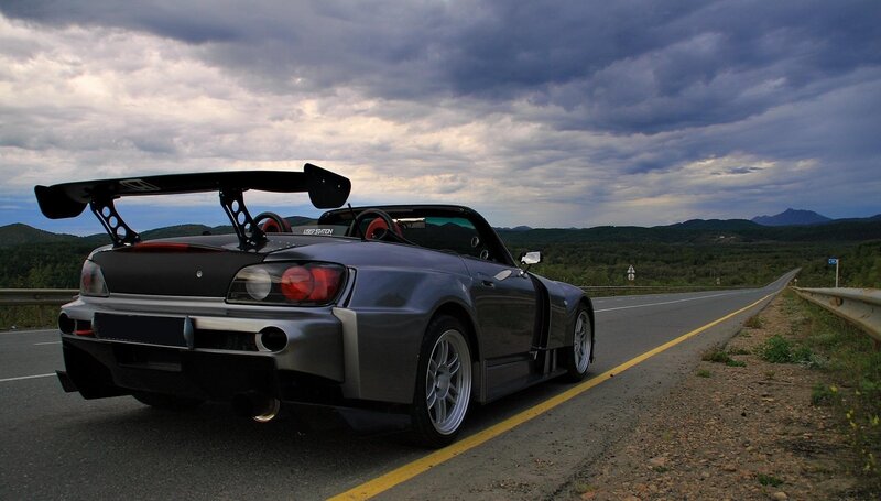 gray sports car on mountain road