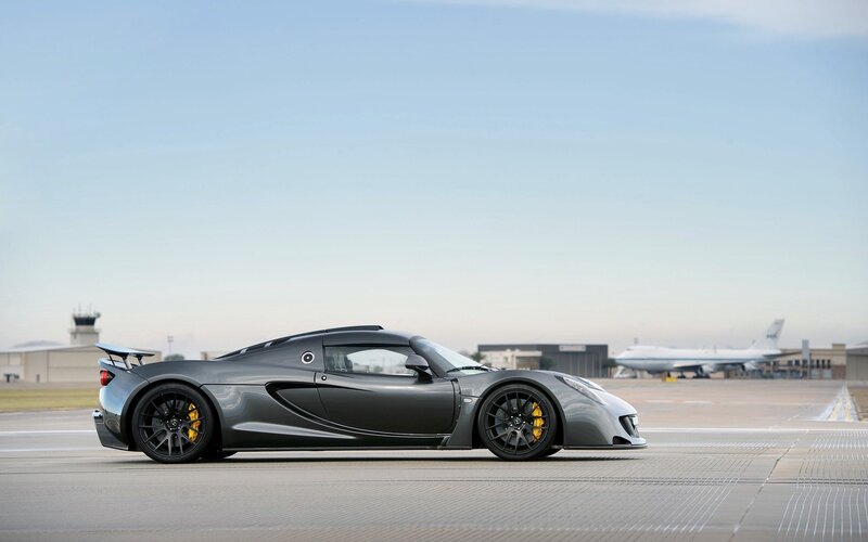 gray sports car on tarmac