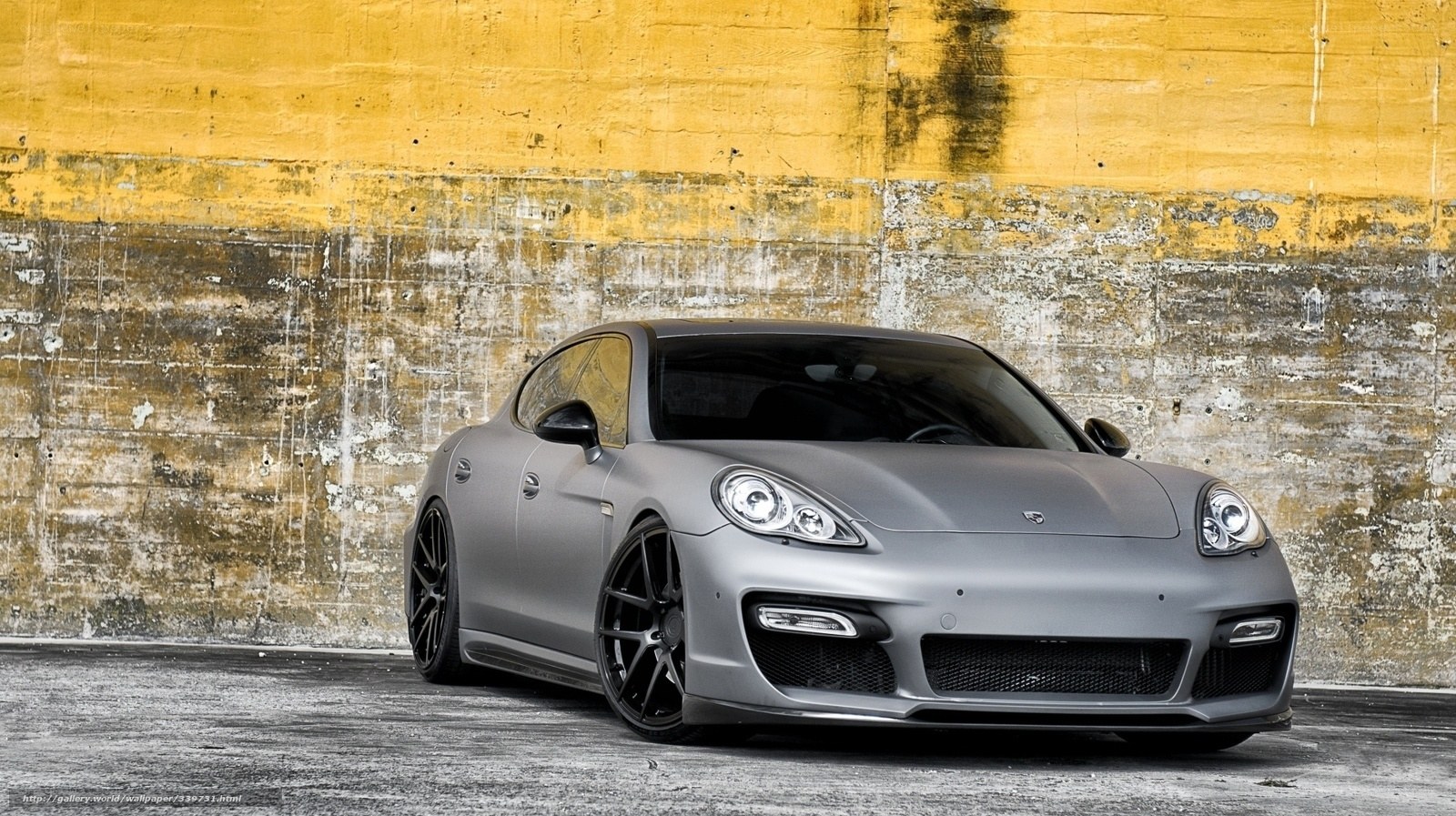 gray sports car on yellow wall