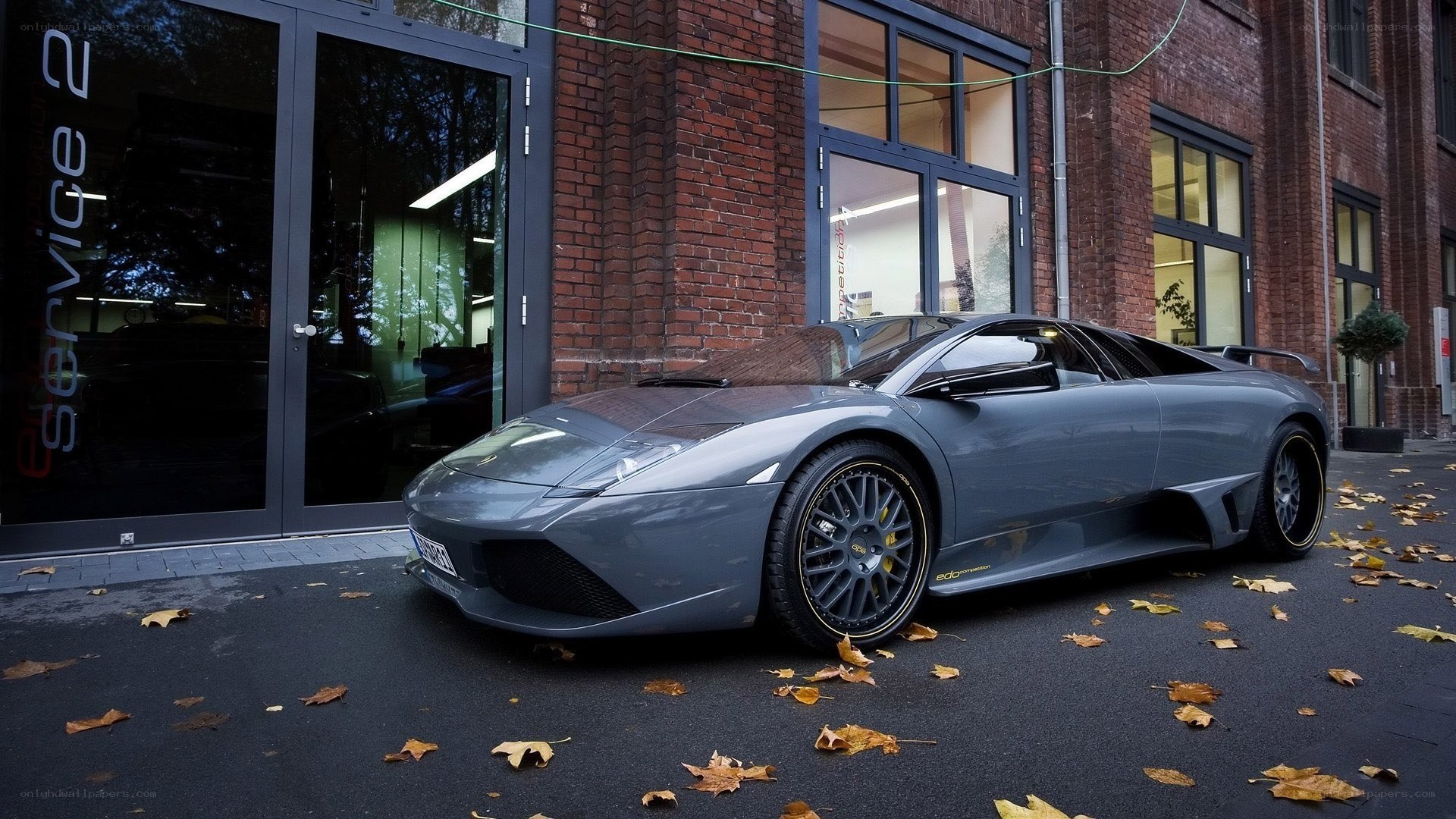 gray sports car outside building