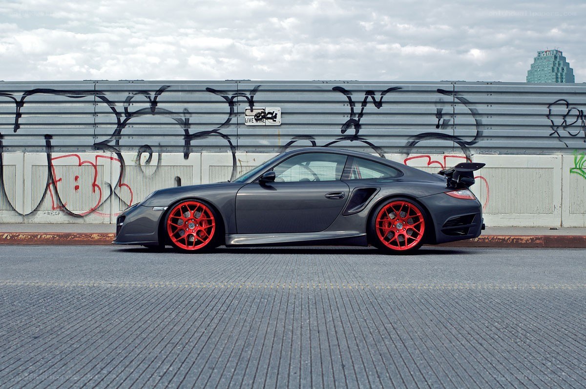 gray sports car with red wheels