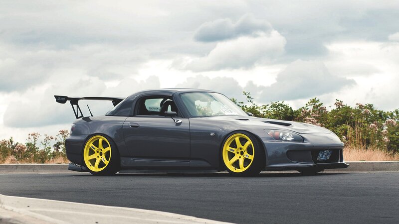 gray sports car with yellow wheels