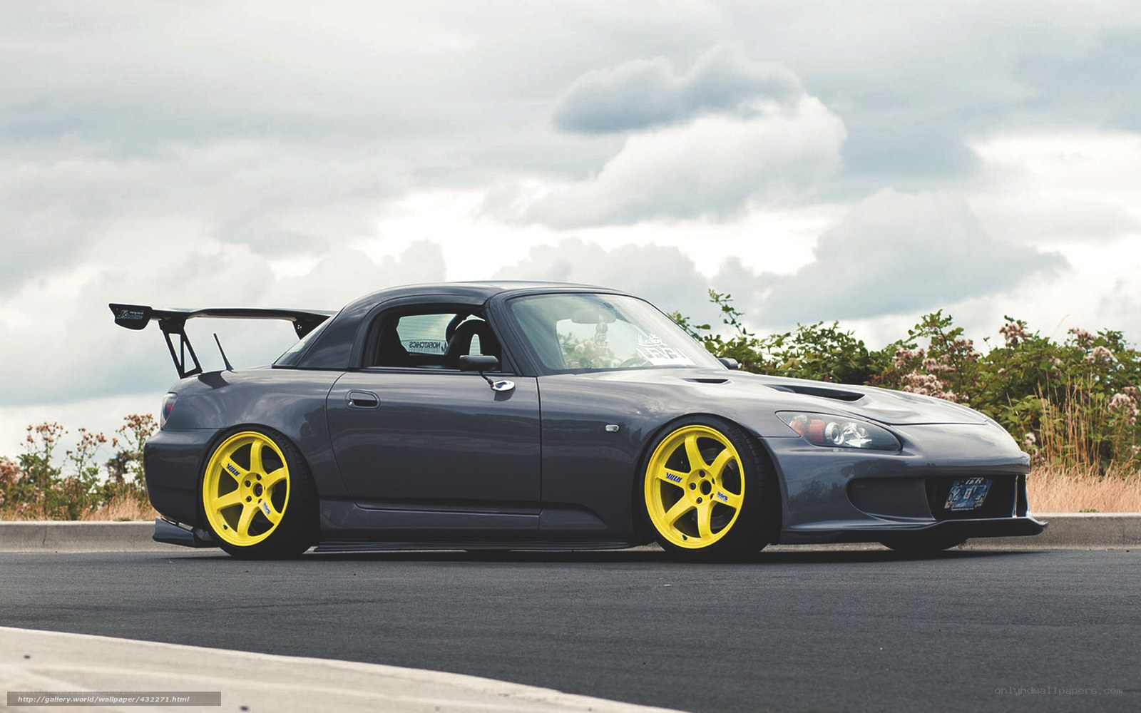 gray sports car with yellow wheels