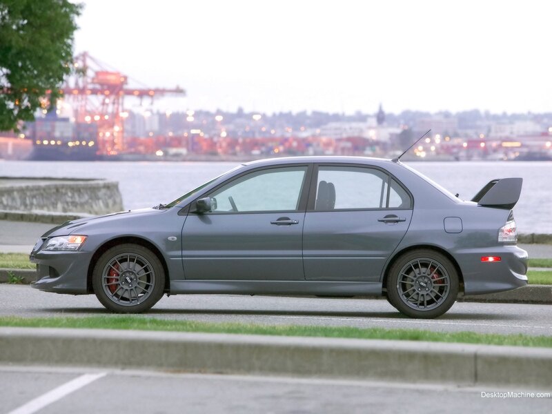 gray sports sedan by the water