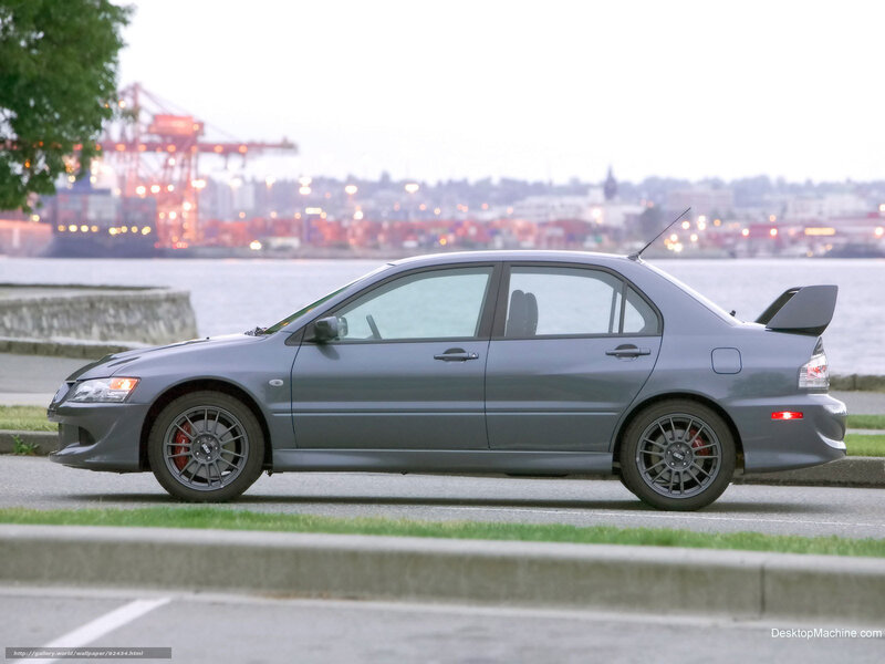gray sports sedan by the water