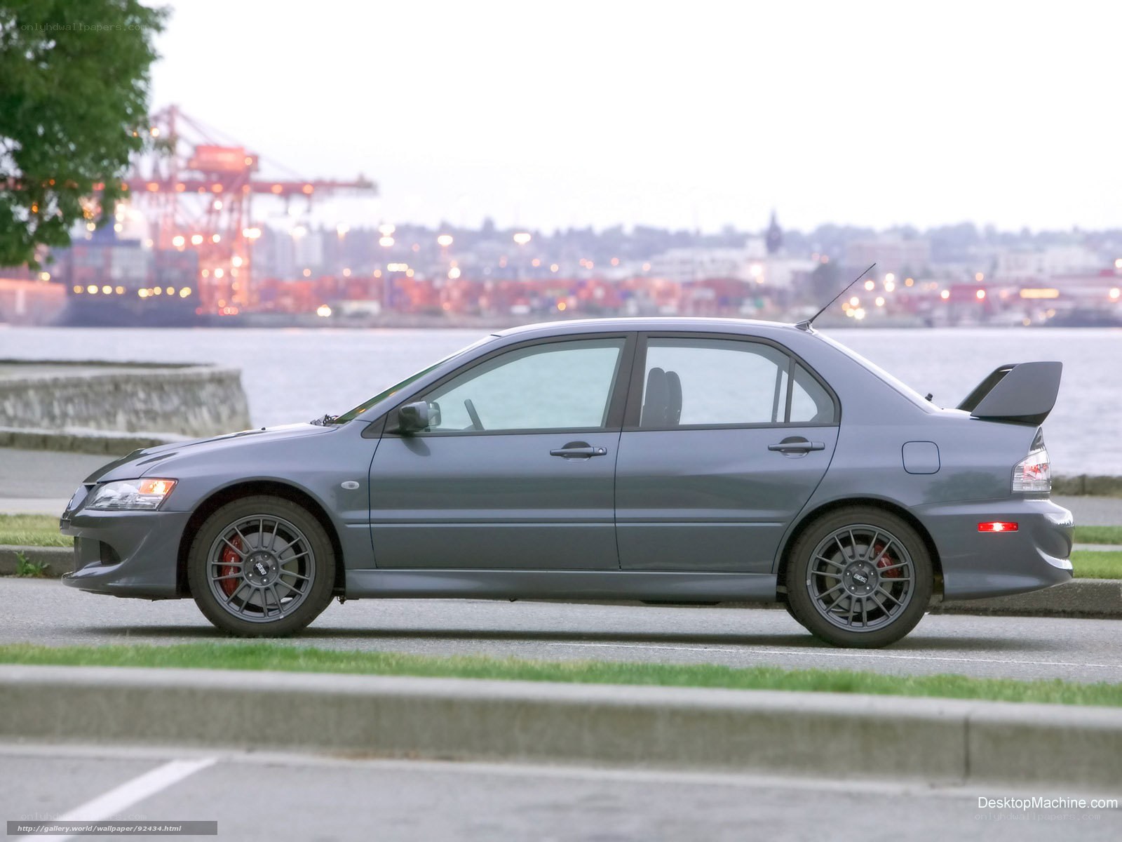gray sports sedan by the water