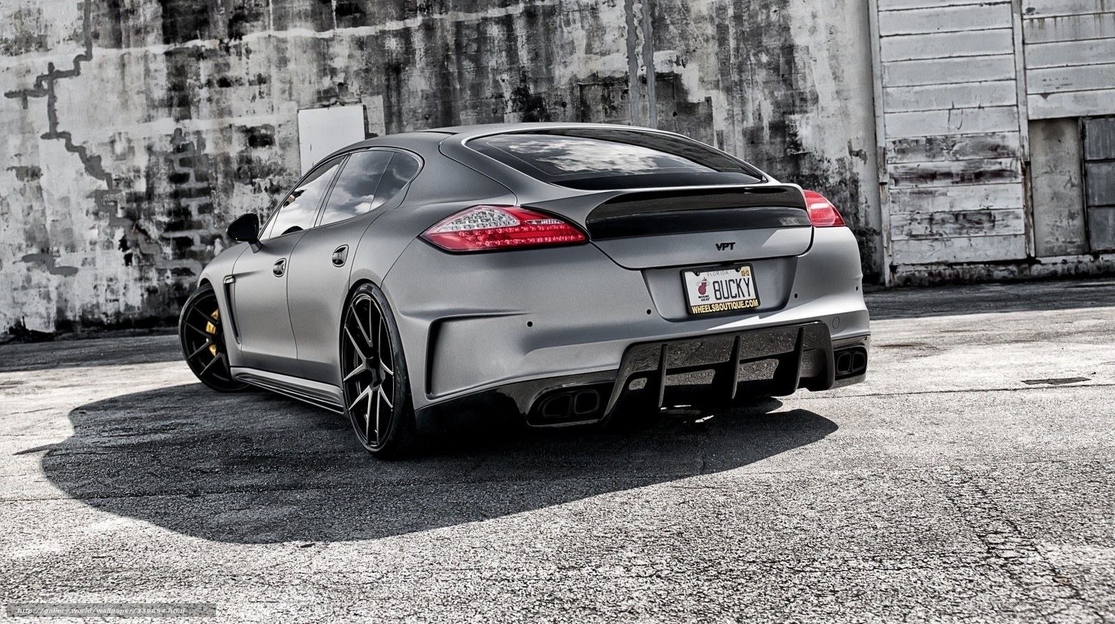 gray sports sedan in urban setting