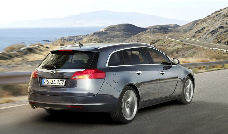 gray station wagon on coastal road