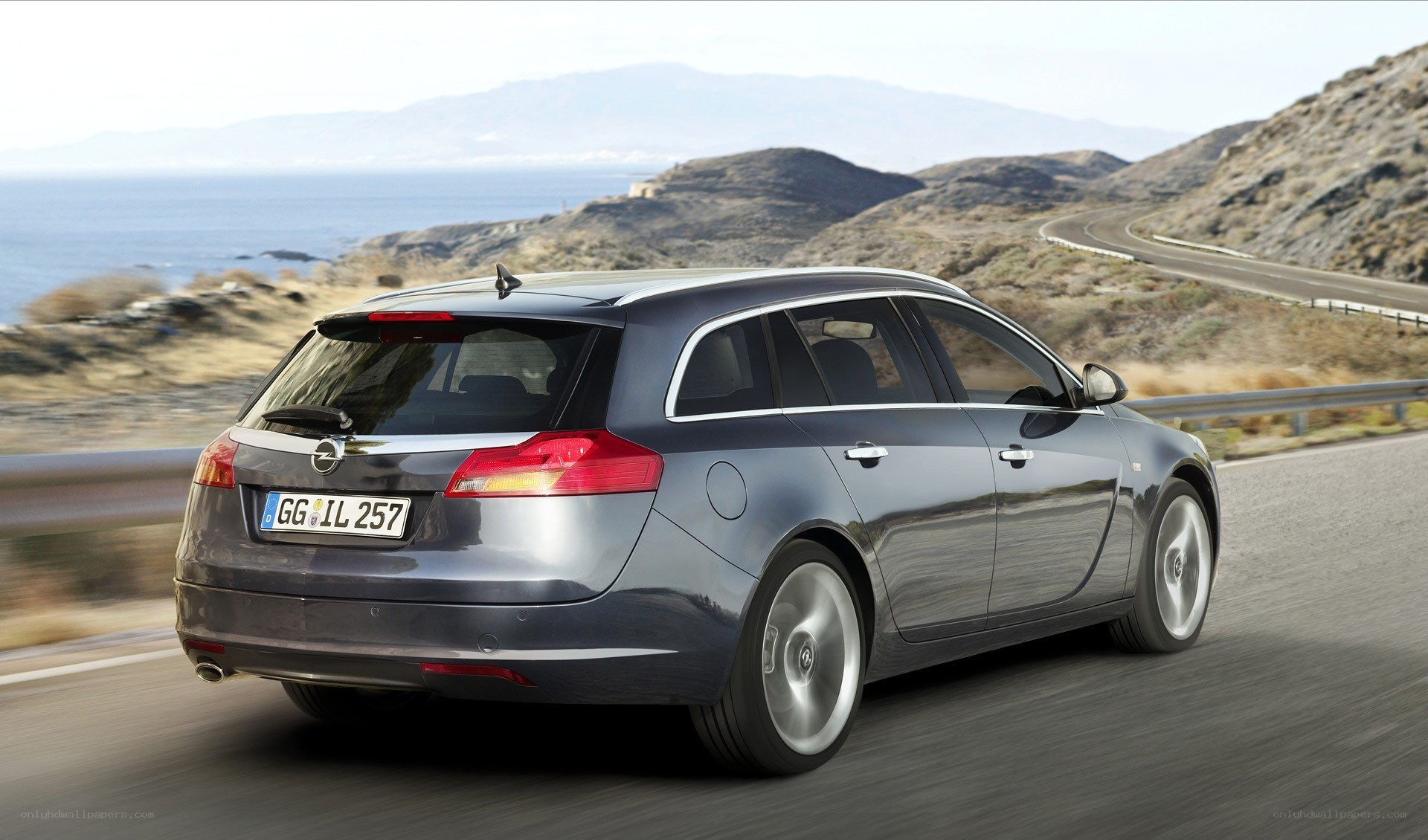gray station wagon on coastal road