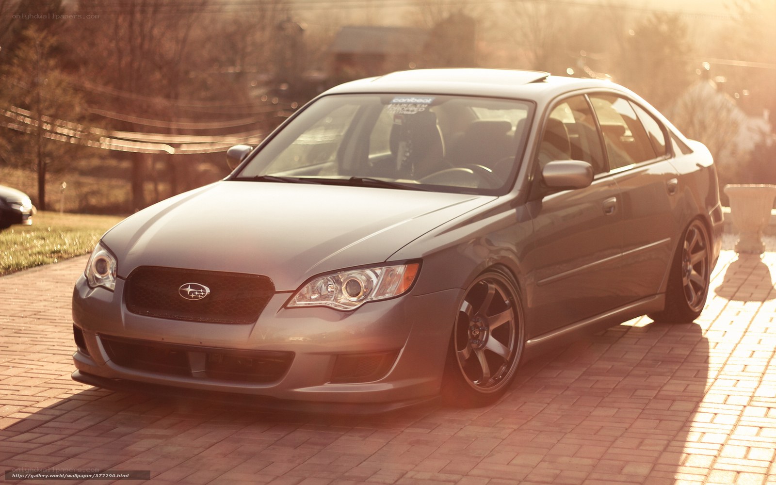 gray subaru sedan at sunset