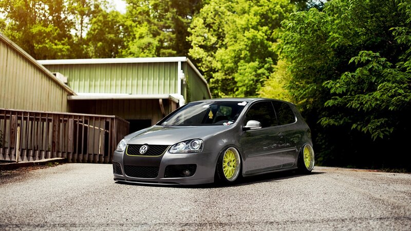 gray volkswagen golf with yellow wheels