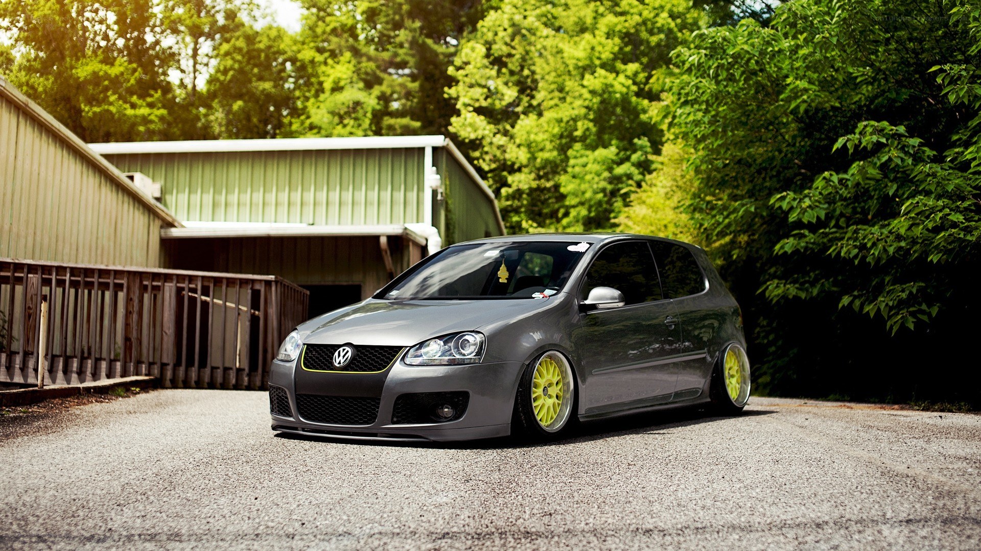 gray volkswagen golf with yellow wheels