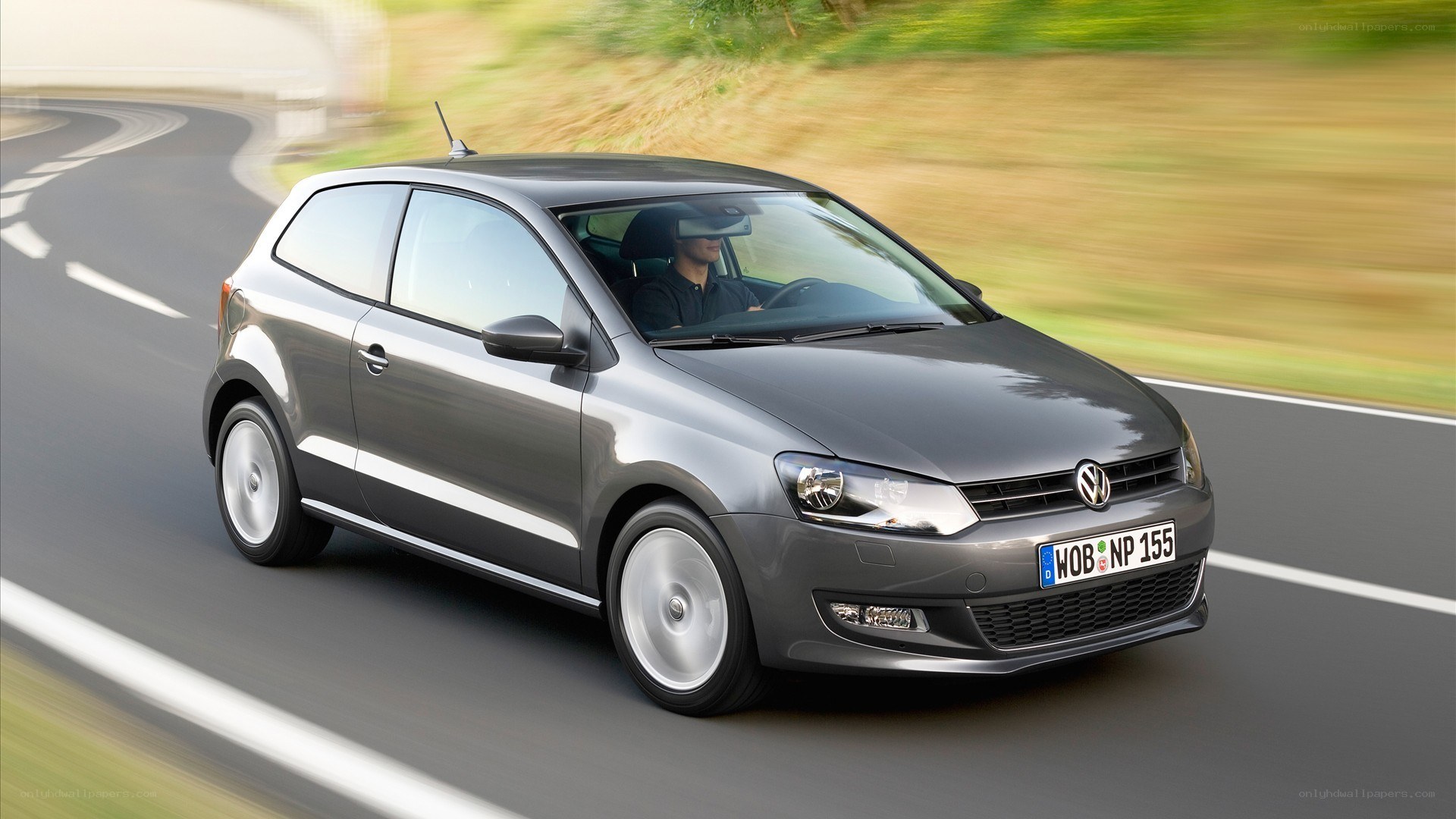 gray volkswagen polo driving on road