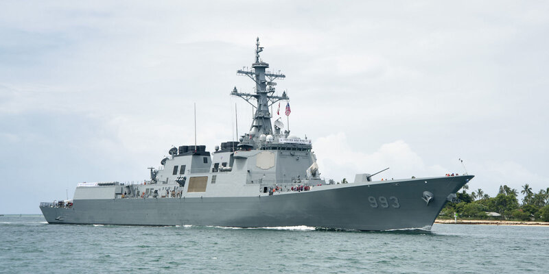Gray Warship at Sea — Calm, Afternoon, Photograph, Ocean, Sky, Trees