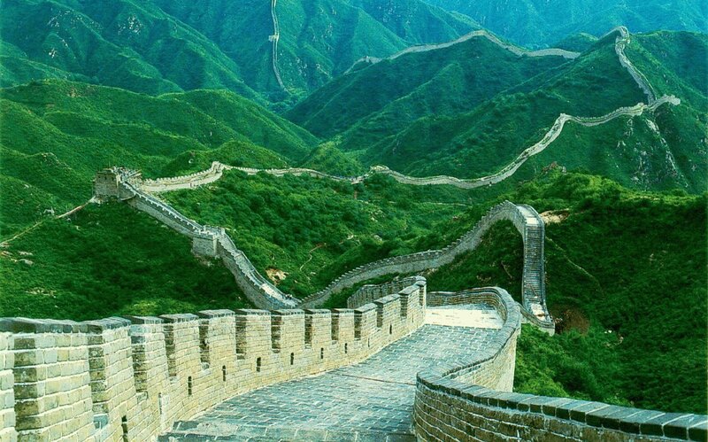 Great Wall winding through green mountains
