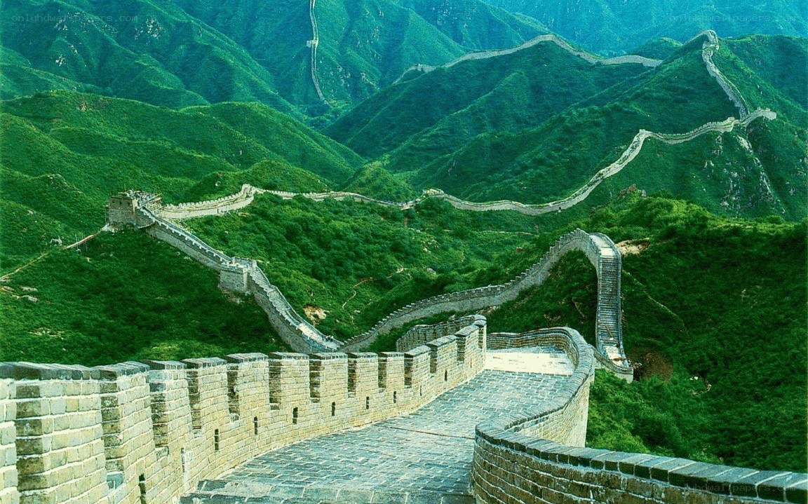 Great Wall winding through green mountains