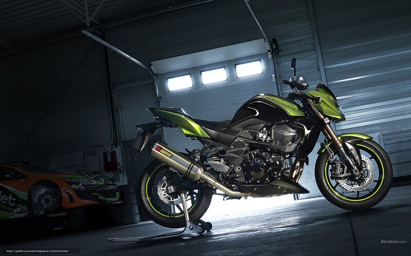 Green and black motorcycle in garage
