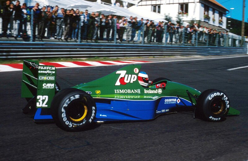 Green and blue race car on track
