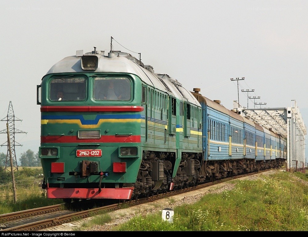 Green and blue train on tracks