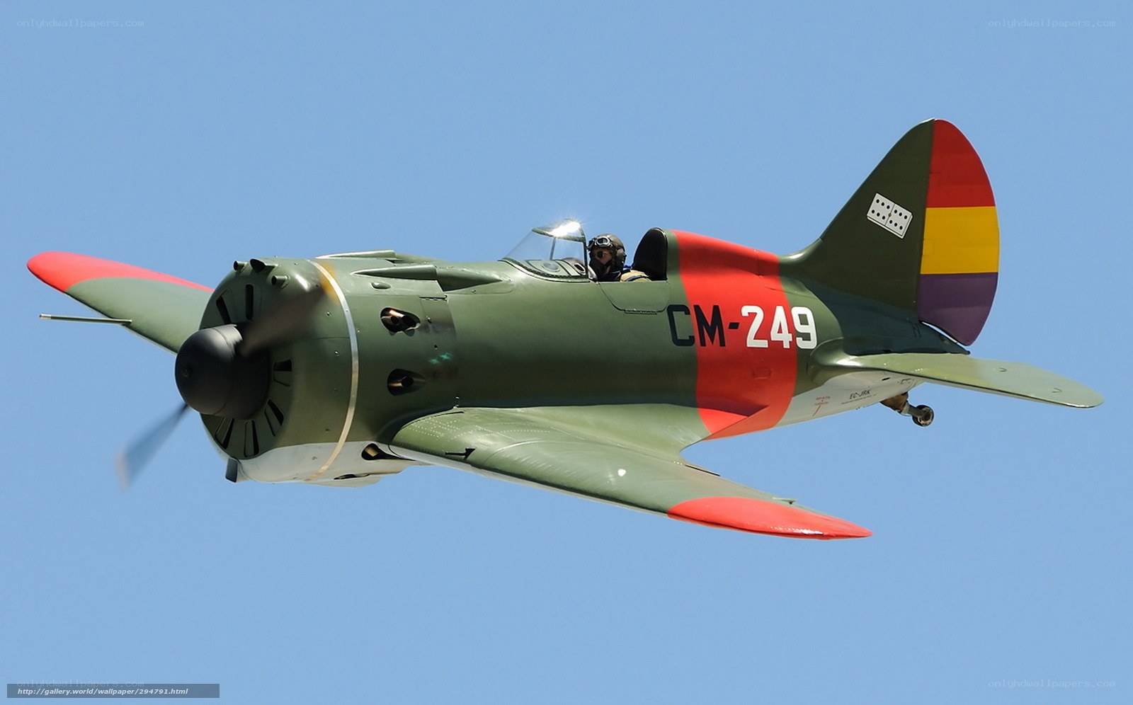 Green and red airplane in flight
