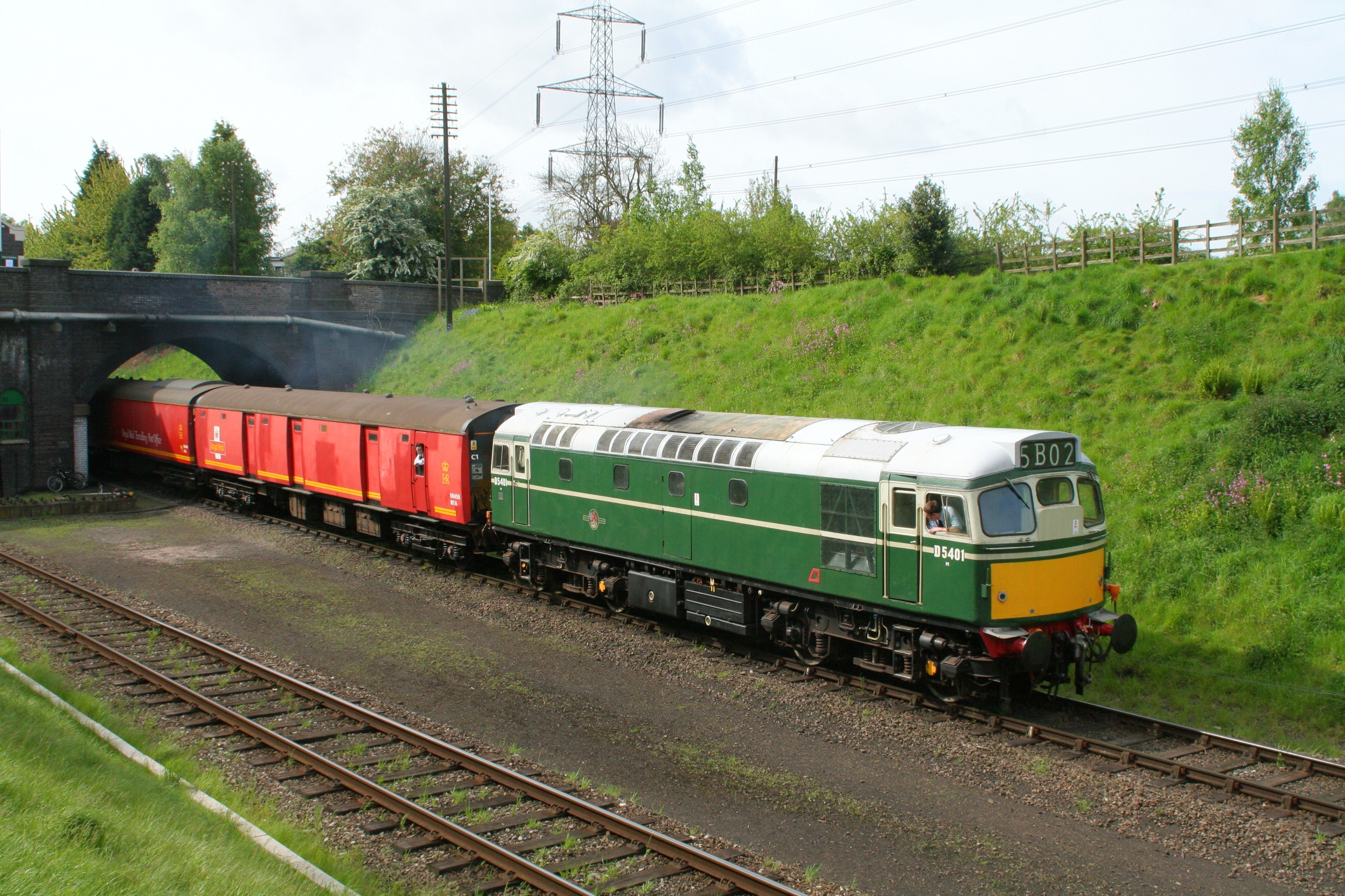Green and red train on tracks
