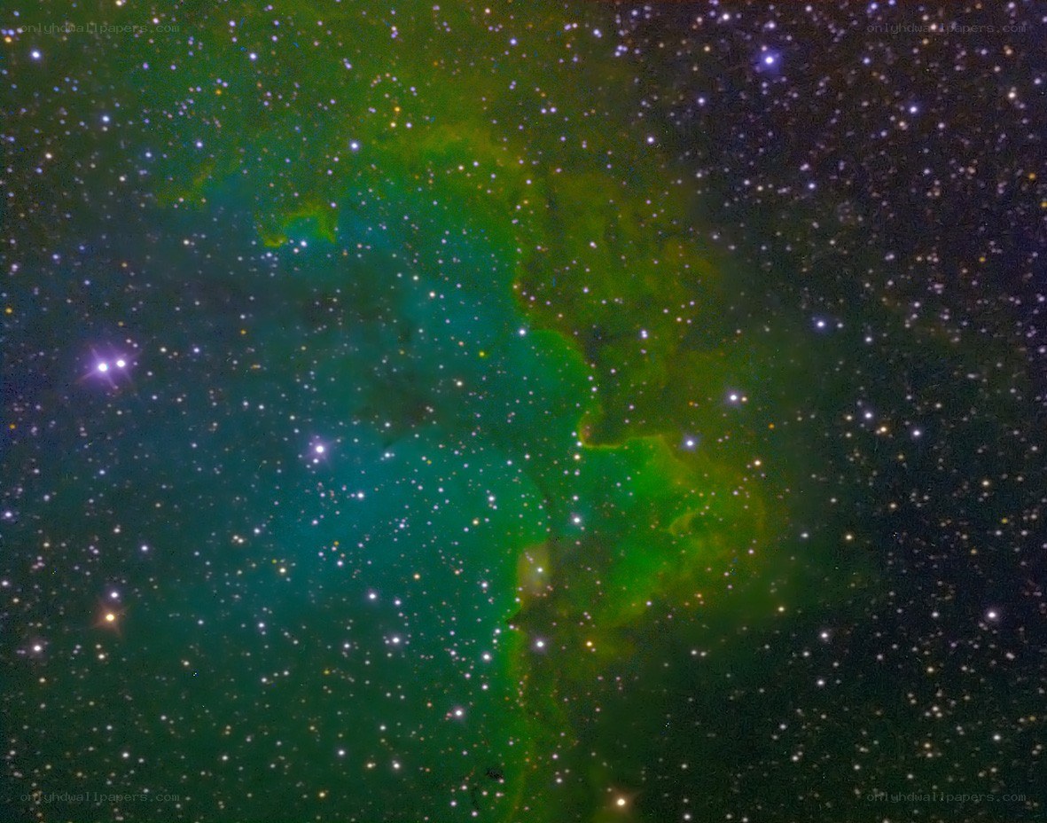 Green and teal nebula in space
