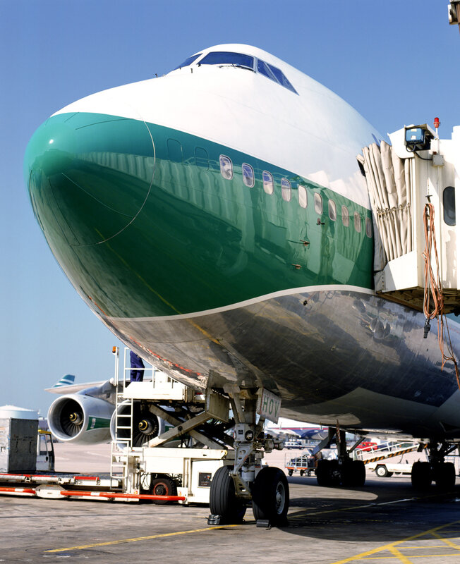 Green and white airplane at airport