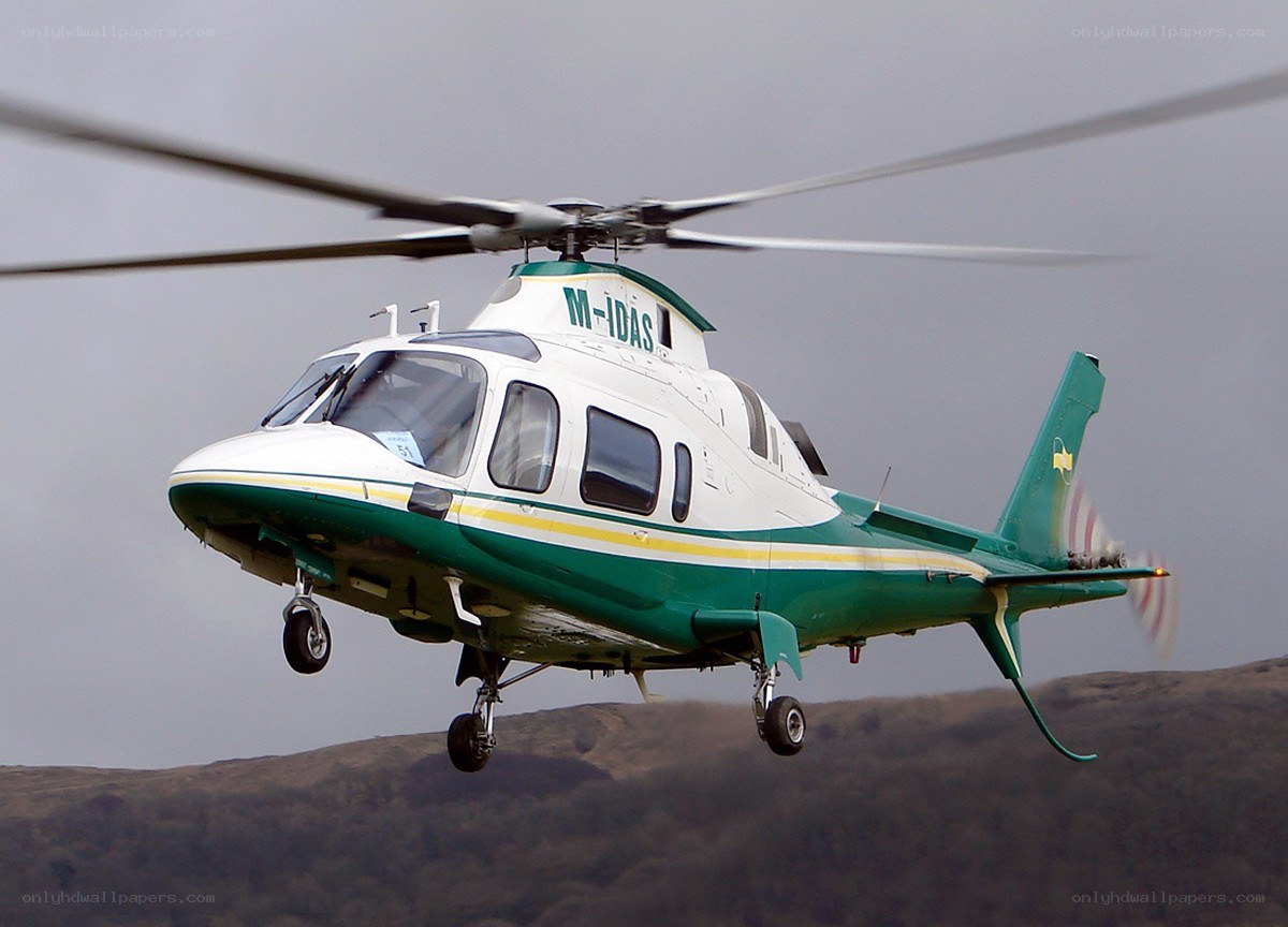 green and white helicopter in flight