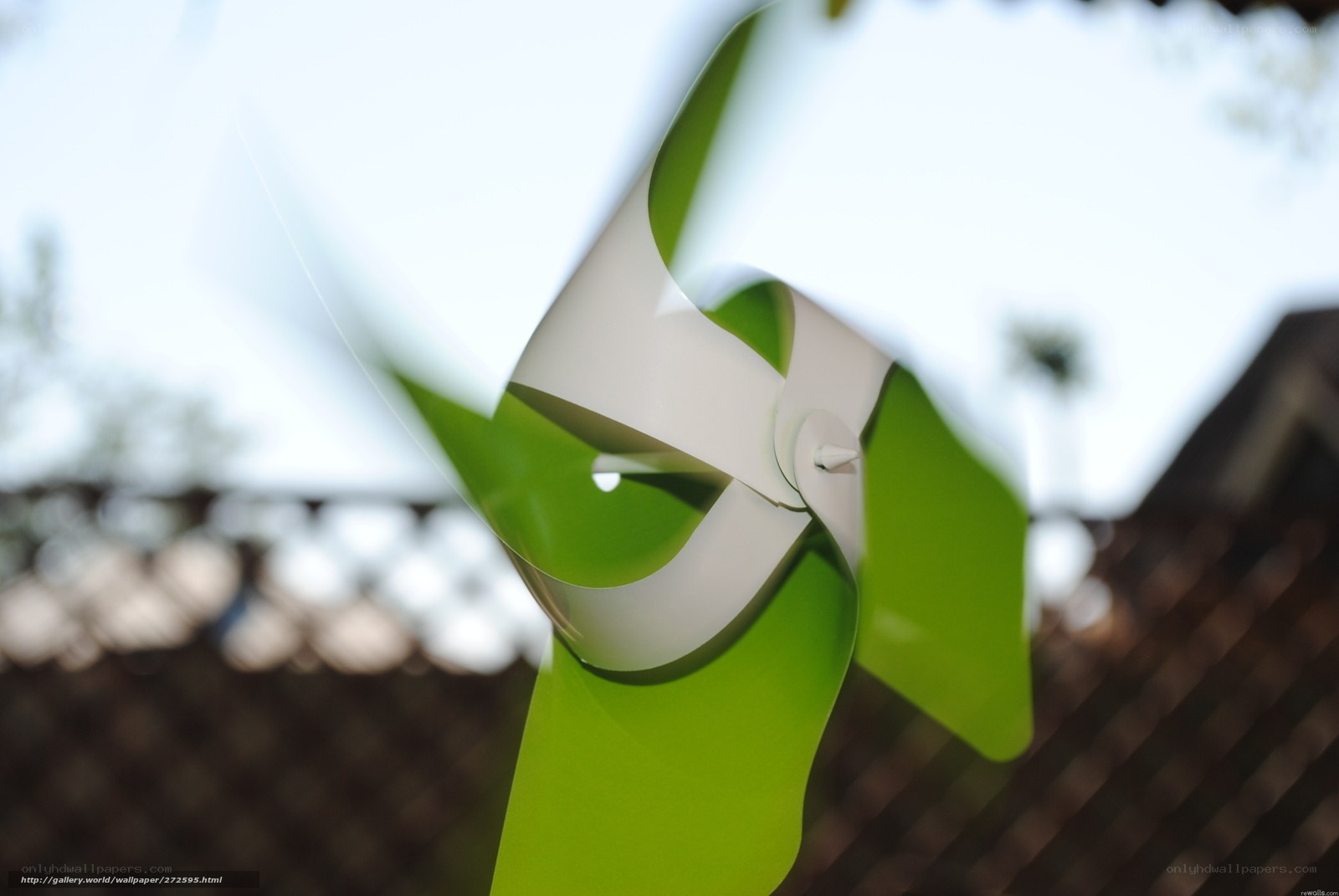 Green and white pinwheel spinning