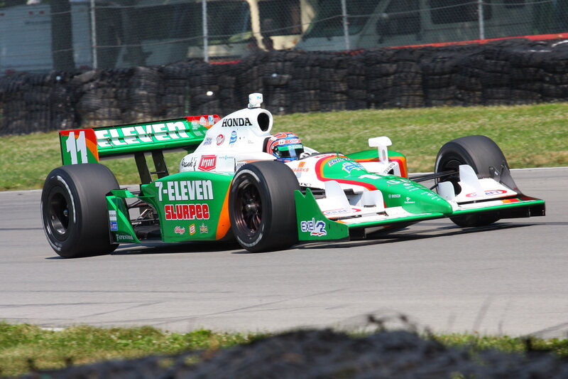 Green and white race car on track