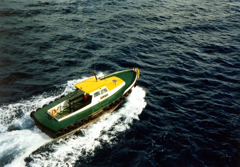 Green and yellow boat on open sea