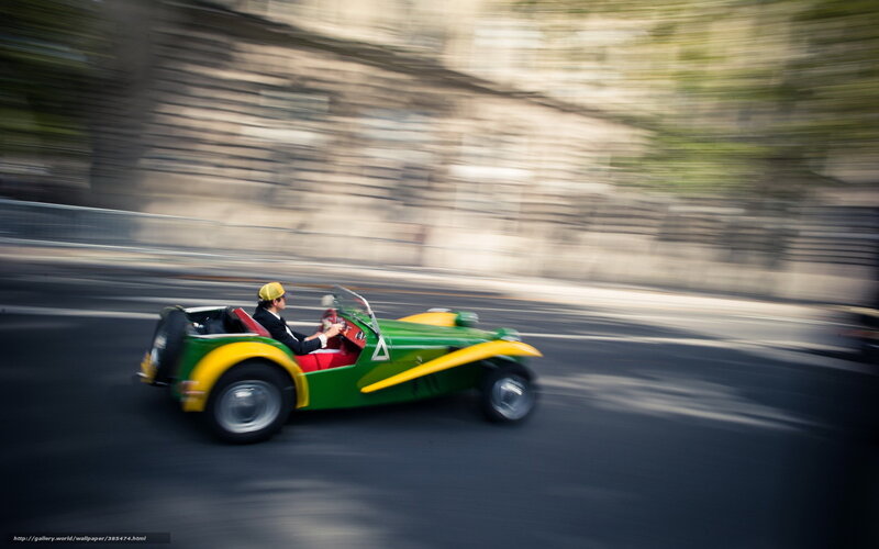 Green and yellow car in motion