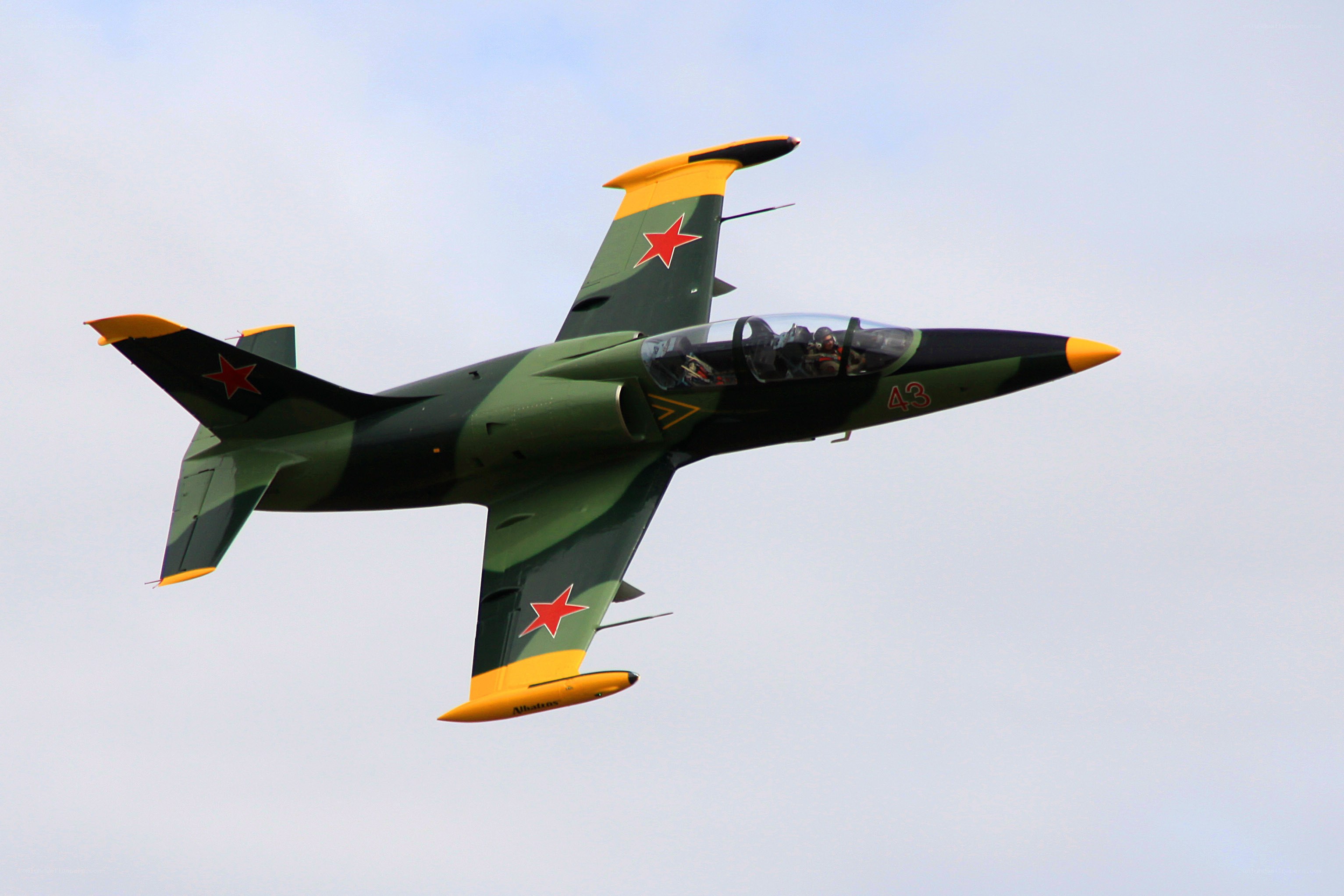 Green and yellow jet in flight
