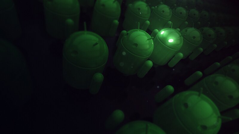 Green Android figures in dark space