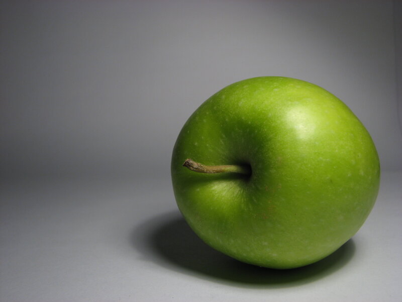green apple on gray background