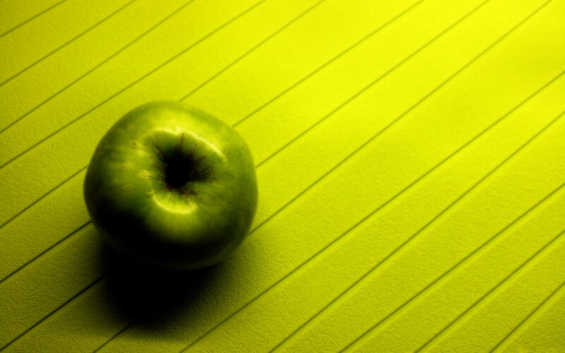 green apple on lined surface
